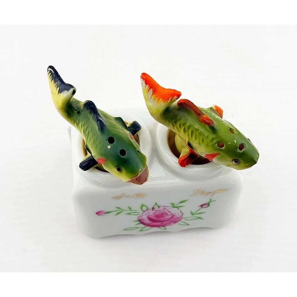 Vintage Japanese porcelain nodder fish salt & pepper shakers with a floral base